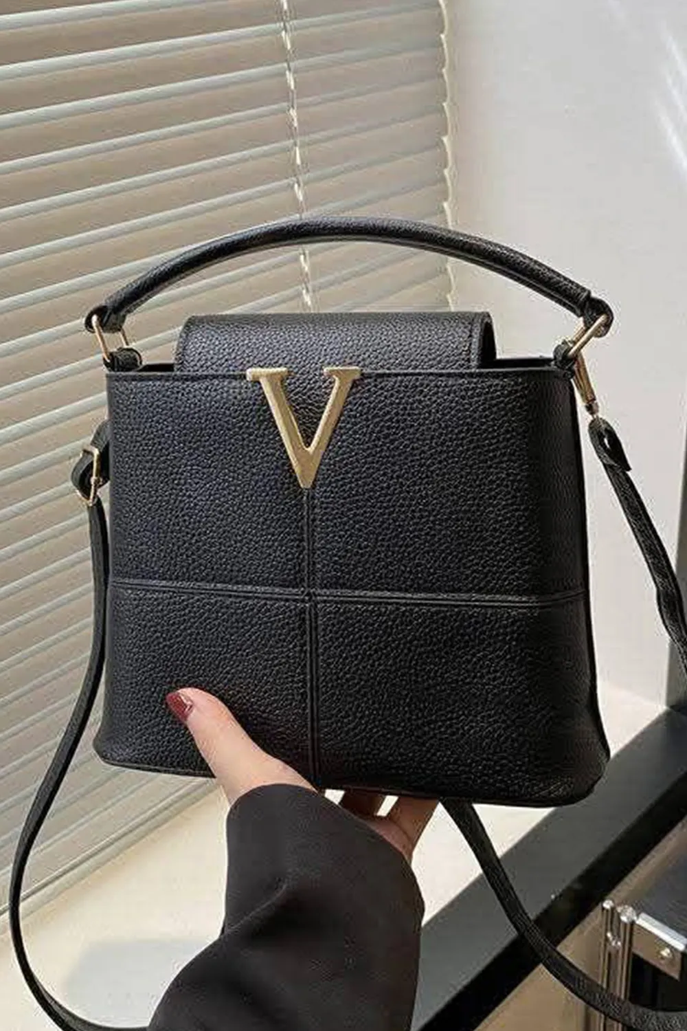 حقيبة يد نسائية مع زخرفة معدنية على شكل حرف "V" في المقدمة